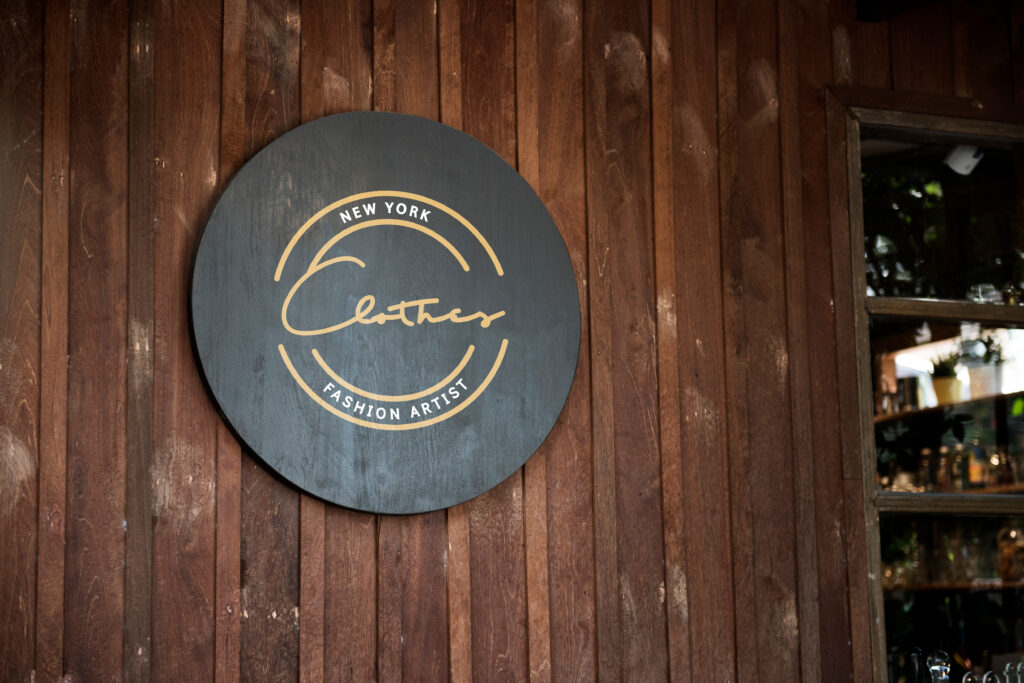 Black,Sign,On,A,Wooden,Wall,Mockup