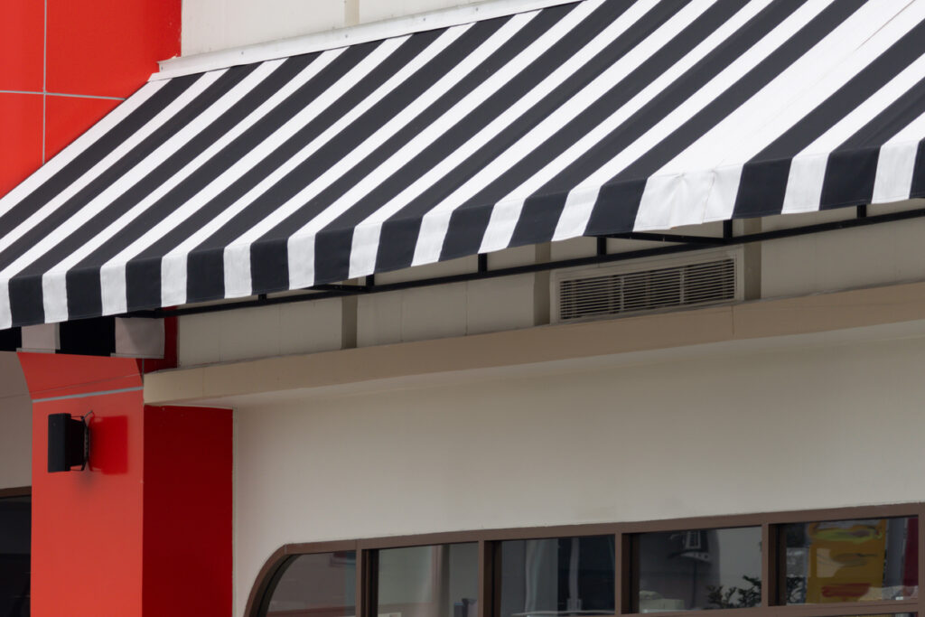A black and white striped awning over a store